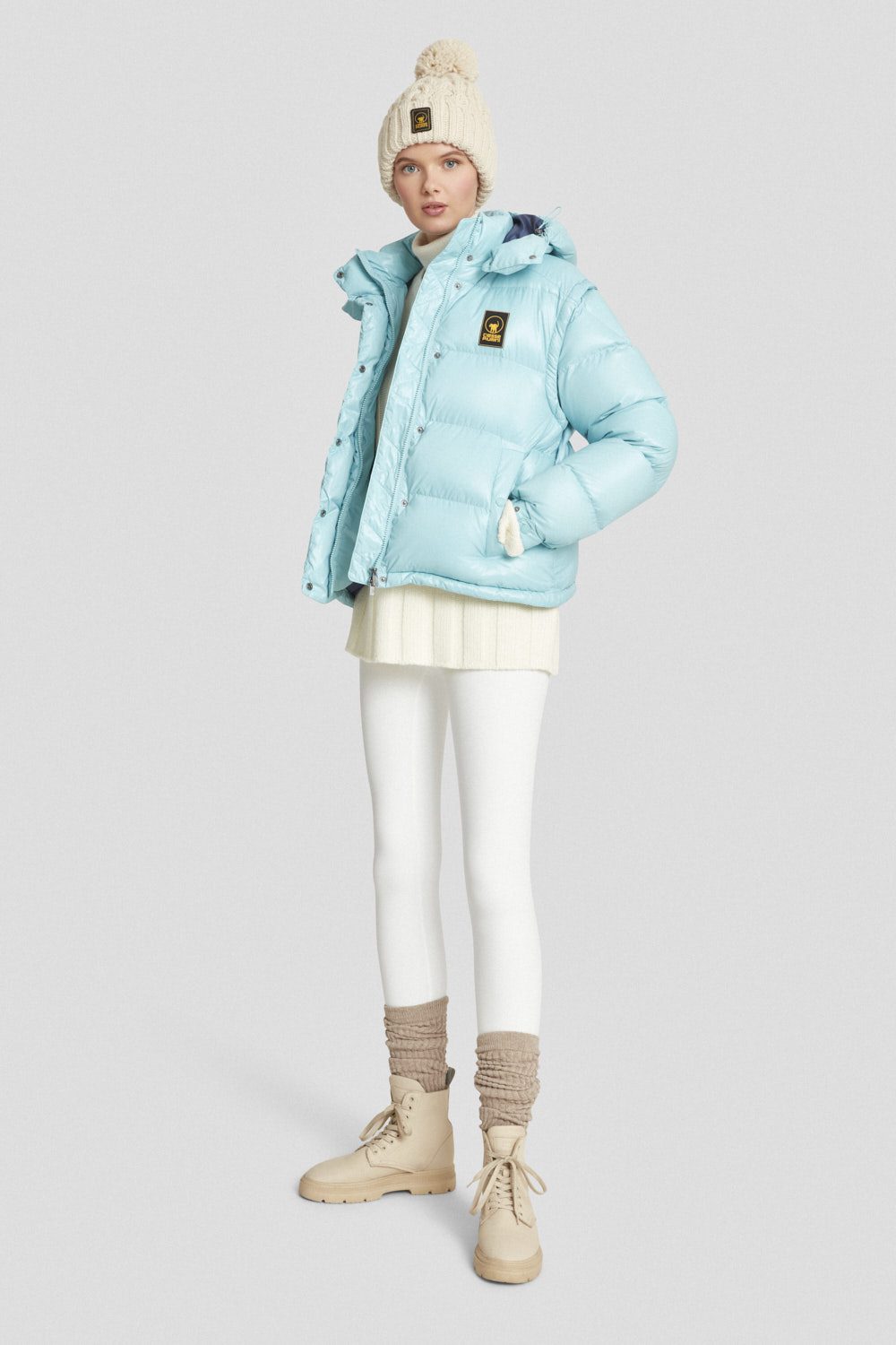 Piumino trapuntato azzurro con cappuccio e maniche staccabili