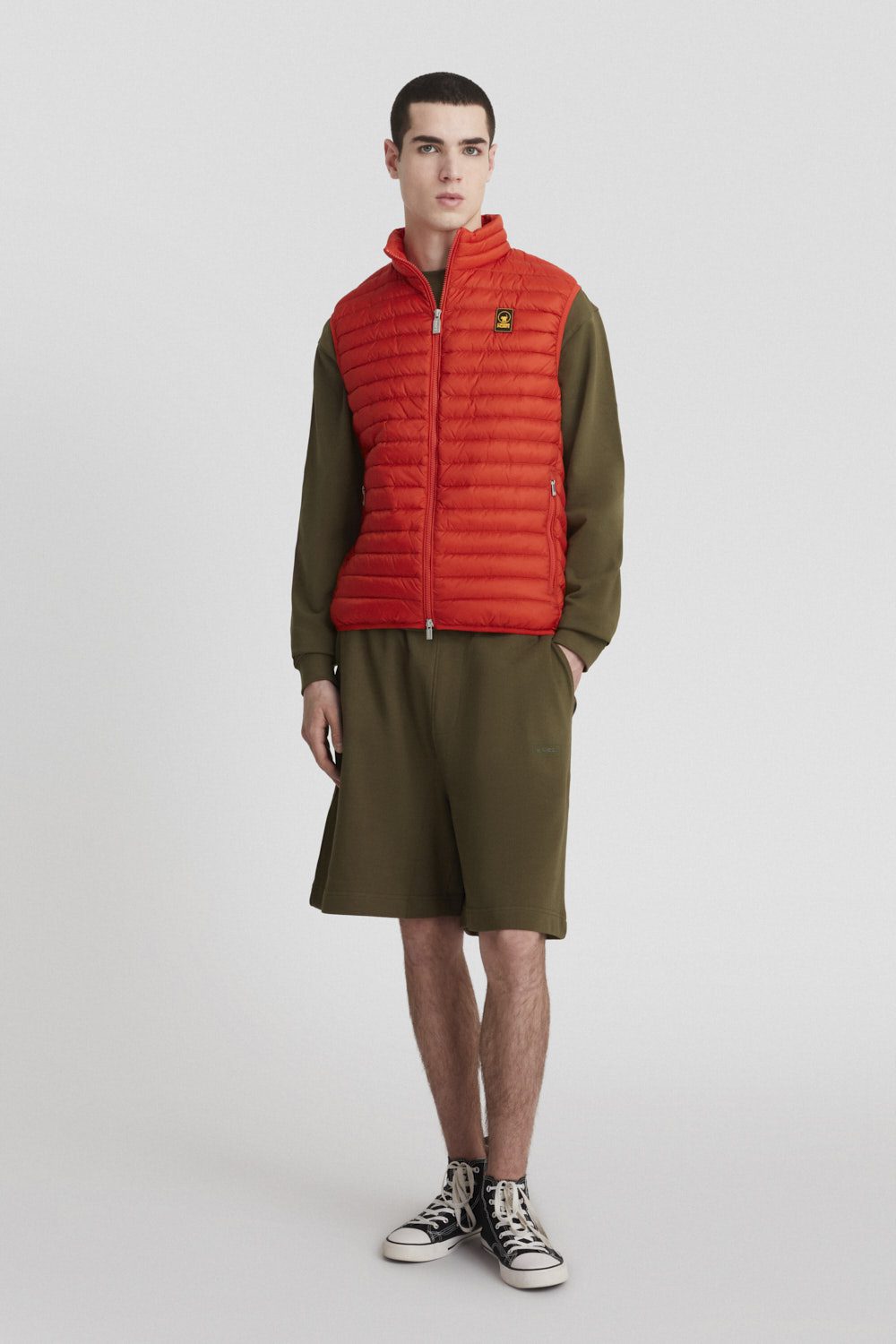 Piumino arancione smanicato imbottito in vera piuma